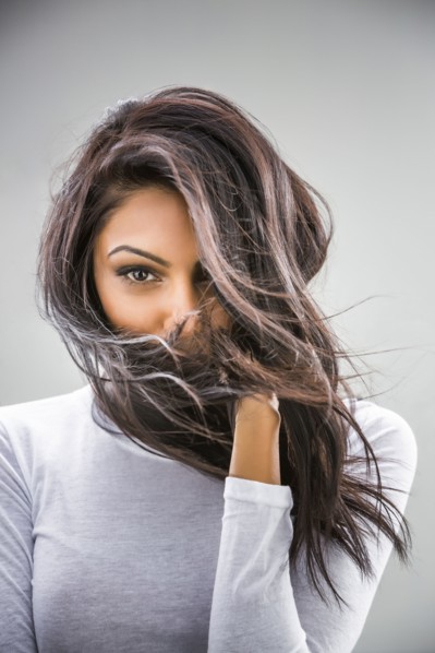 Hair blowing in face of Indian woman