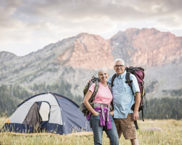 Caucasian couple camping on mountain