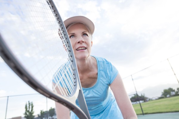 Caucasian woman holding tennis racket