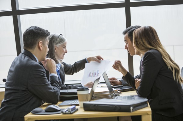Business people examining chart in meeting