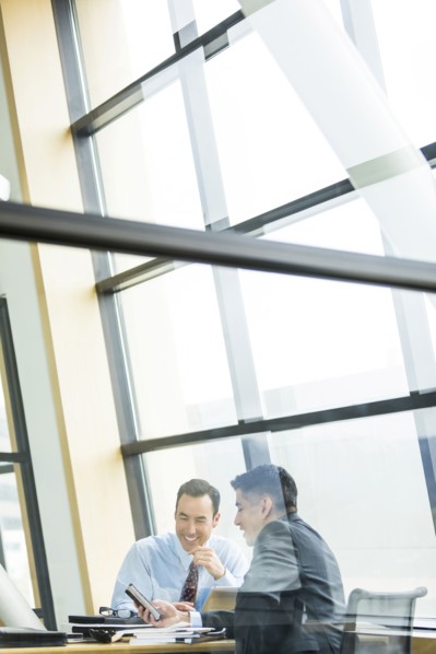 Businessmen smiling in meeting