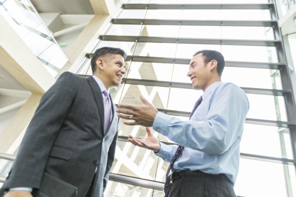 Smiling businessmen talking in lobby