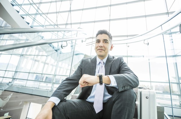Portrait of smiling Mixed Race businessman sitting on staircase