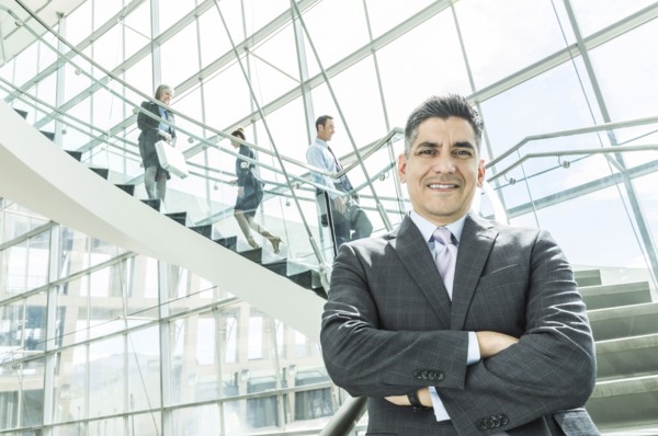 Portrait of businessman standing near staircase