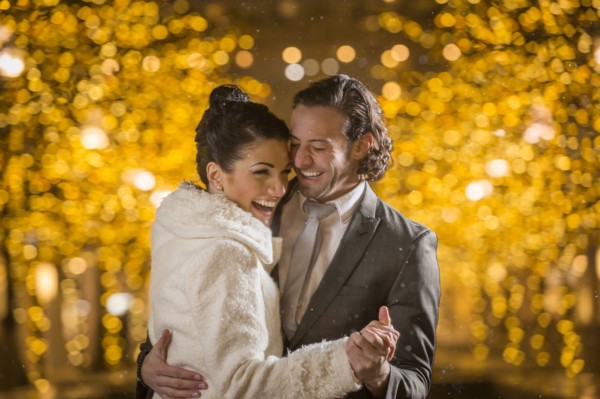 Caucasian couple dancing outdoors at night