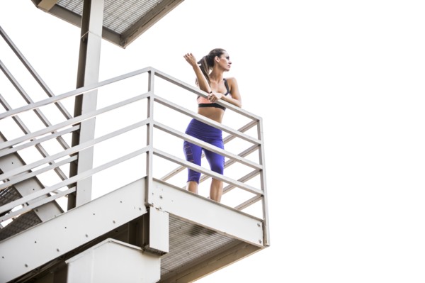 Caucasian woman leaning on urban staircase