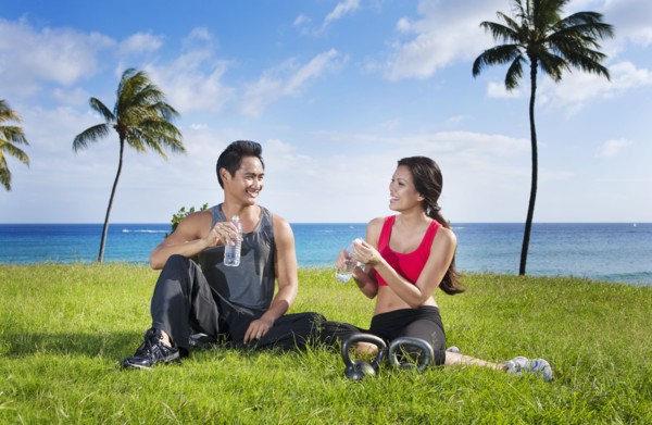 Couple drinking water after exercise at waterfront