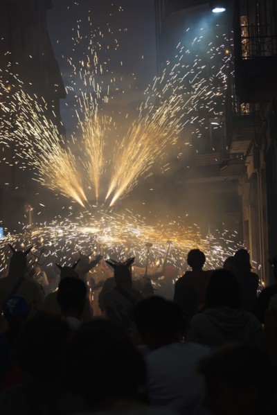 Crowd watching sparks in parade at night