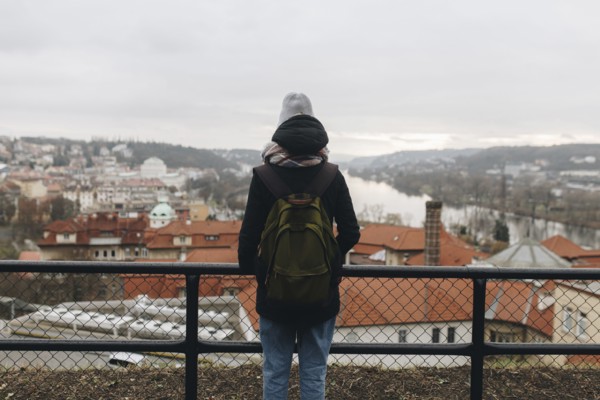 Caucasian woman wearing backpack admiring scenic view of city