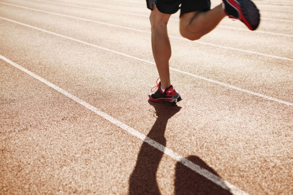 Male athlete running on a track