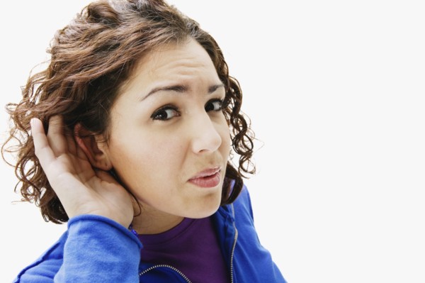 Portrait of woman holding hand up to ear