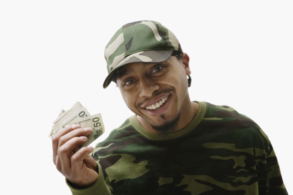 Portrait of African man holding handful of money