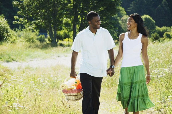 African couple carrying picnic basket