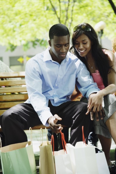 African couple looking at shopping bags