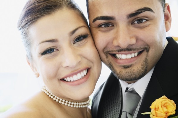 Multi-ethnic bride and groom hugging