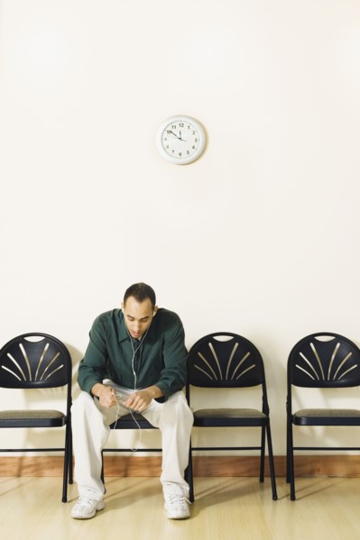 Mixed Race man sitting in waiting area