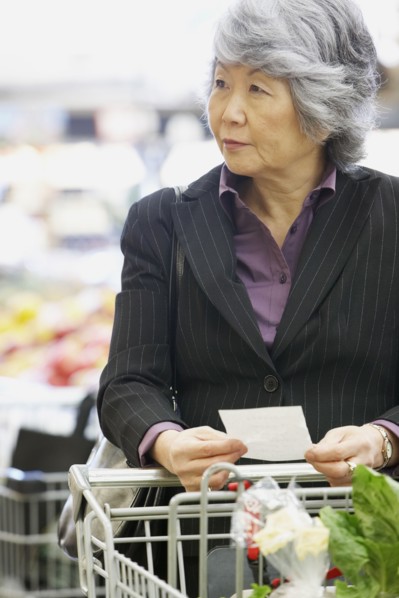 Senior Asian woman shopping in grocery store