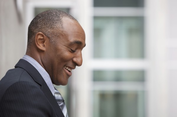Mixed race businessman laughing