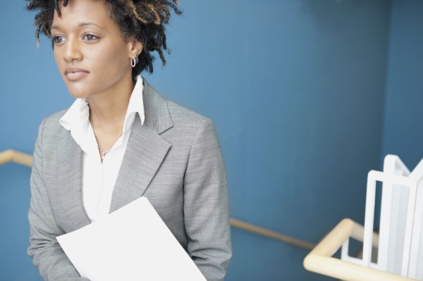 Mixed race businesswoman in stairwell
