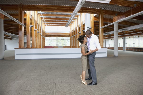 Couple dancing in empty office space