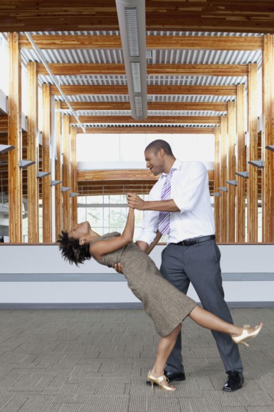 Couple dancing in empty office space