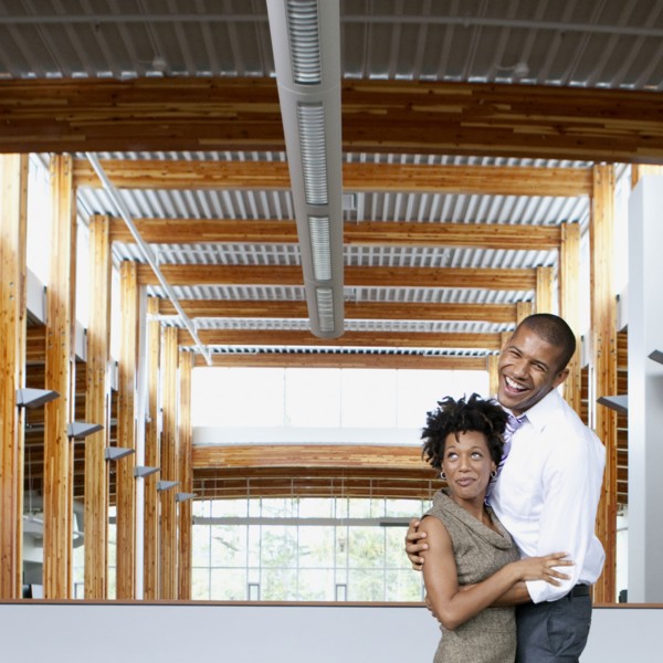 Couple laughing in empty office space