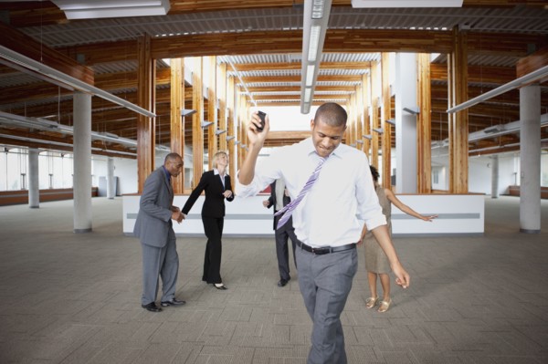 Business people dancing in empty office space