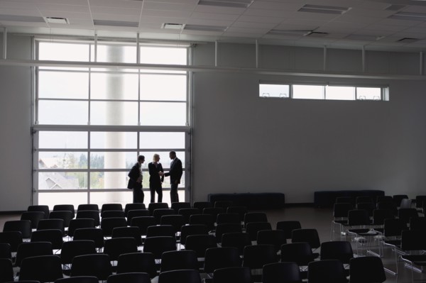 Business people talking in empty auditorium