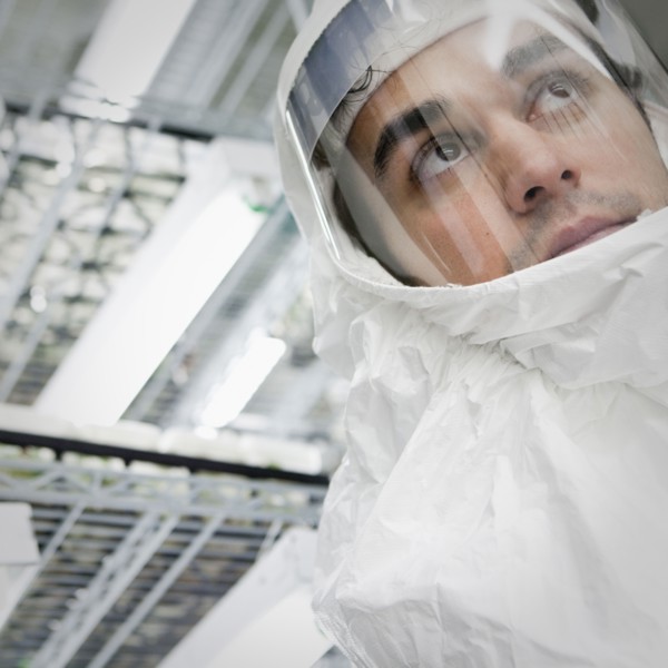 Middle Eastern scientist in clean suit in laboratory