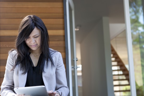 Mixed race real estate agent using digital tablet