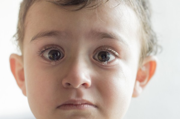 Face of Hispanic boy crying