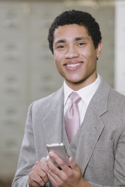 Mixed race businessman holding cell phone