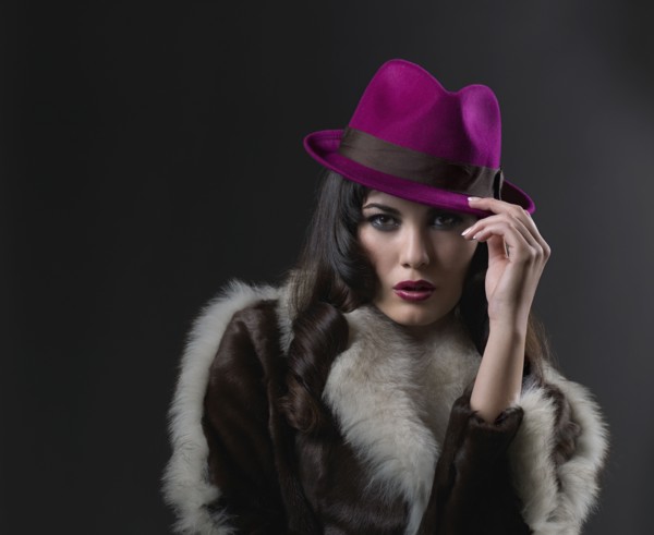 Mixed Race woman wearing hat and fur coat