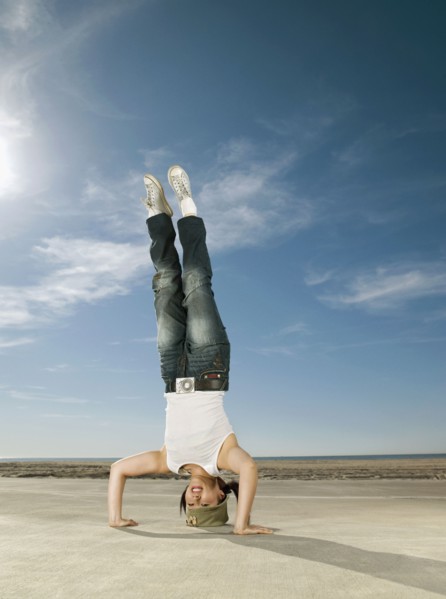 Asian woman doing headstand