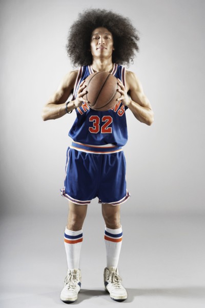 Mixed race basketball player holding basketball