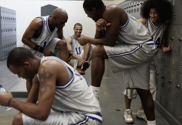 Multi-ethnic basketball players dressing in locker room