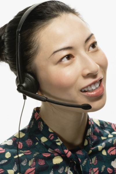 Studio shot of Asian woman wearing headset