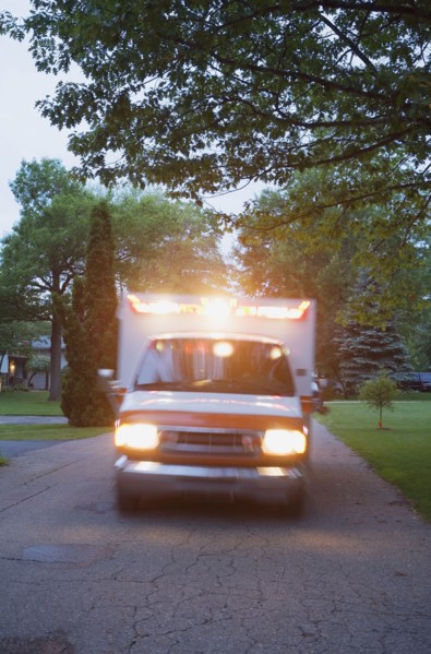 Ambulance with lights on in residential area