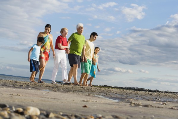 Surface shot of Hispanic family walking on beach
