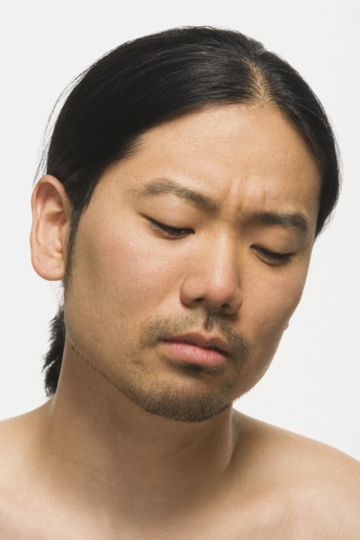 Asian man looking down