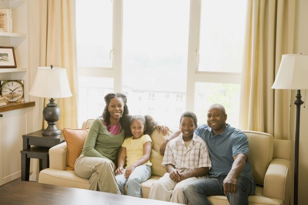 African American family sitting in living room
