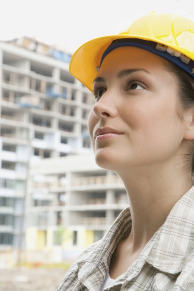Mixed race woman in hard-hat on construction site