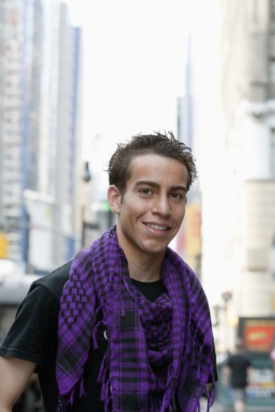 Hispanic man smiling on urban street
