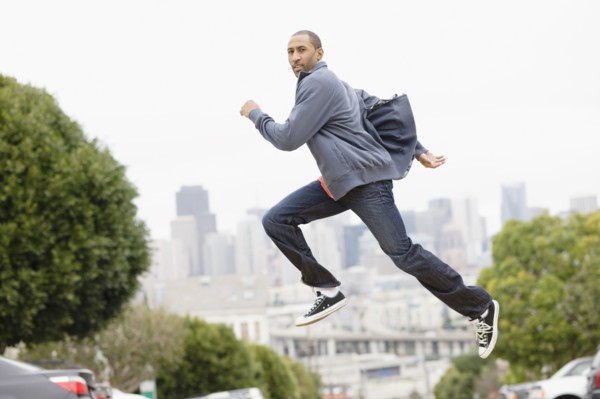 African American man running on urban street