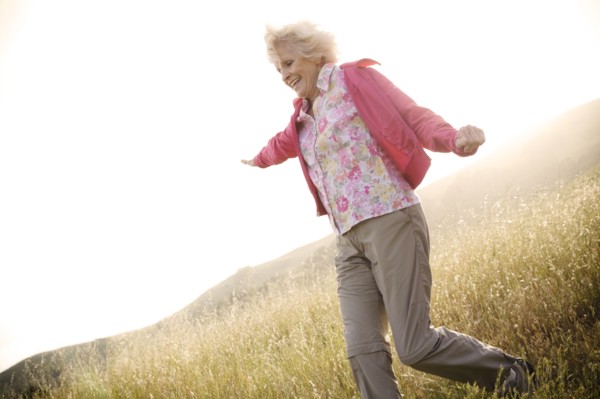 Caucasian woman running down hill