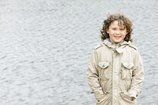 Smiling Caucasian boy with hands in pockets