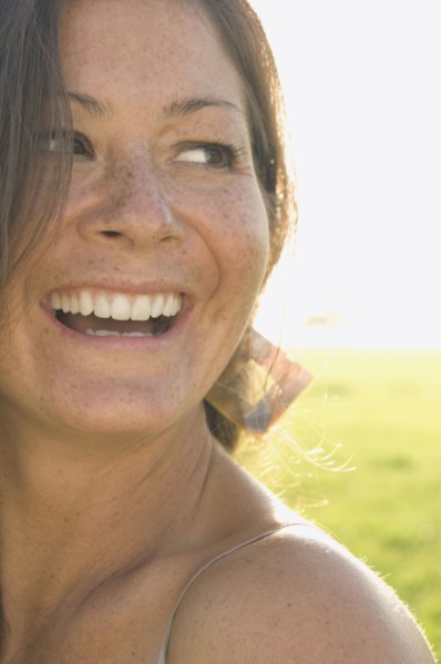 Portrait of woman in sunlit meadow