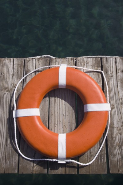 Round life preserver on wooden dock