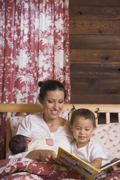 Hispanic mother reading to daughter