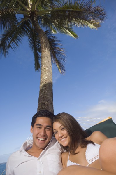 Multi-ethnic couple laying in hammock